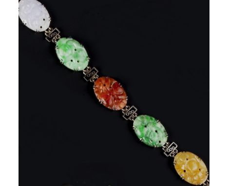 A JADE PANEL BRACELET, the oval jade panels alternating in shades of green, lilac, reddish-orange, yellow and black, each pie