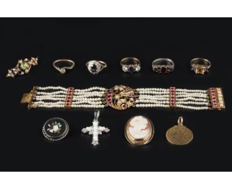 A COLLECTION OF JEWELLERY, comprising an Eastern panel bracelet, highlighted with half pearls and red stones, (pearls unteste