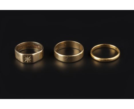 THREE RINGS, comprising a 22ct gold wedding band, an 18ct gold wedding band, and an 18ct gold and gypsy star set band ring (3