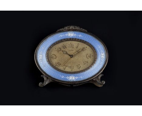 A LADY'S BOUDOIR ALARM TIMEPIECE BY ETERNA, the oval dial with Arabic numerals, to a blue enamel and white metal case, on scr