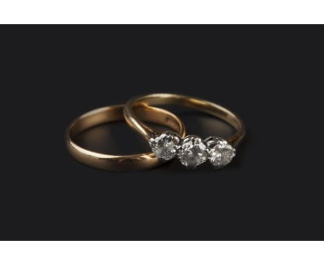 A DIAMOND THREE STONE RING, the round brilliant-cut diamonds in claw setting, two colour precious metal mounted, together wit