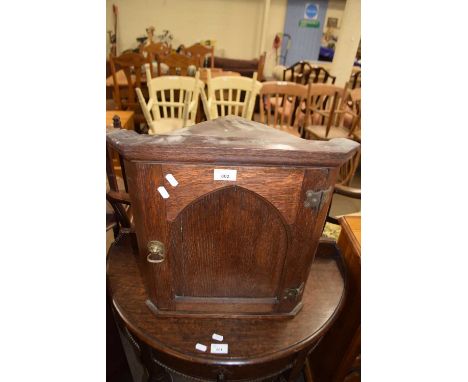 Small oak corner cabinet with arched panel door