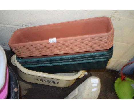Quantity of plastic planters and a large ceramic pot marked Canning