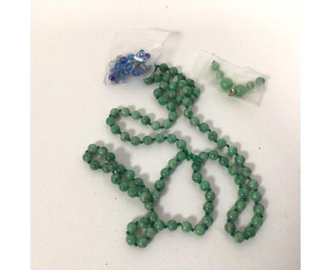 A string of polished stone beads, possibly jade (50cm) and a small quantity of assorted beads (a lot0