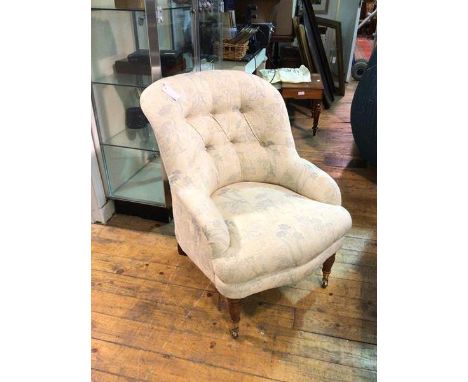 A Victorian style library chair with floral button back upholstery, on turned front supports ending in castors (83cm x 66cm x