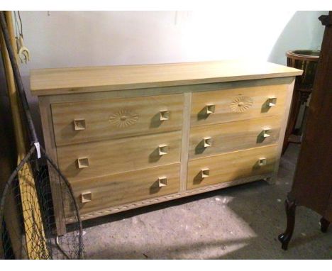 A modern light oak chest of drawers, the rectangular top above two rows of three drawers, the top two with rosette, all with 