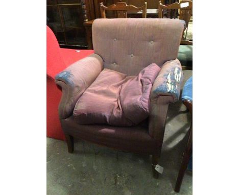 A 1920s/30s armchair, with button back above scroll arms, with cushion seat, on straight supports (upholstery a/f) (76cm x 64