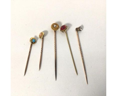 A group of five stick pins, early 20thc., one set with seed pearl, pin stamped 10, the second with a red stone, stamped 10, t