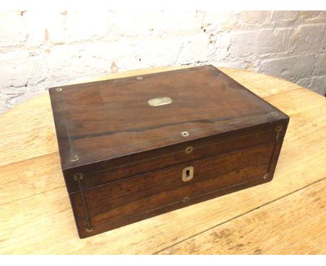 A 19thc rosewood box with mother of pearl inlay, the hinged lid opening to a papered interior with lacquered shelf (11cm x 28