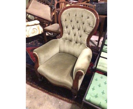 A Victorian mahogany spoon back low chair, with button back, scroll arms with moulding to ends, the serpentine front above tu