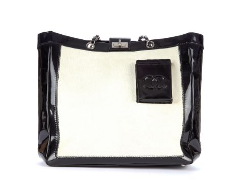 Chanel, a 2.55 Reissue pony hair runway tote, designed with a white pony hair and black patent leather exterior, featuring si