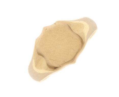 An 18ct gold signet ring, designed as a shield-shape panel, with grooved sides and slightly tapered band, hallmarks for Birmi