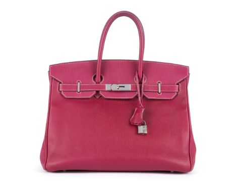 Hermes, a 2013 rose purple Birkin 35 handbag, featuring a pebbled leather exterior, dual rolled handles, top flap and strap c