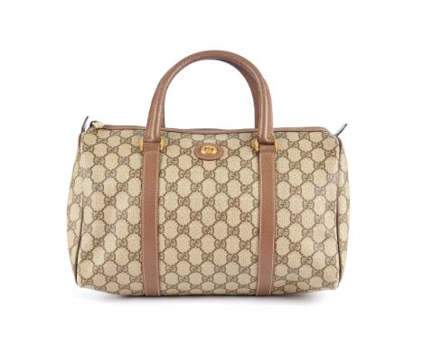 Gucci, a vintage supreme Boston bag, designed with the maker's monogram coated canvas exterior and brown leather trim, featur