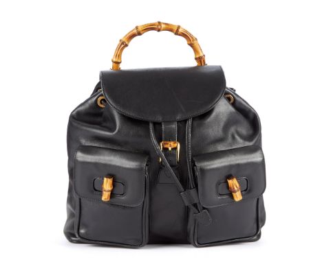 Gucci, a black leather Bamboo GM backpack, featuring a curved bamboo top handle, two front patch pockets with bamboo turn-loc