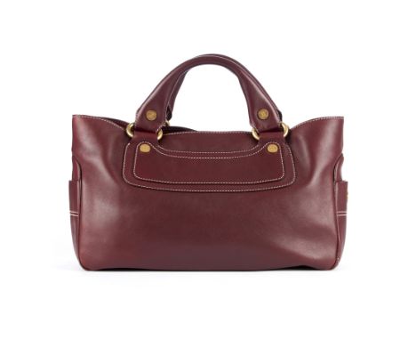 Celine, a Boogie bag, crafted from burgundy leather, with brushed gold-tone logo engraved hardware, two small side pockets, d