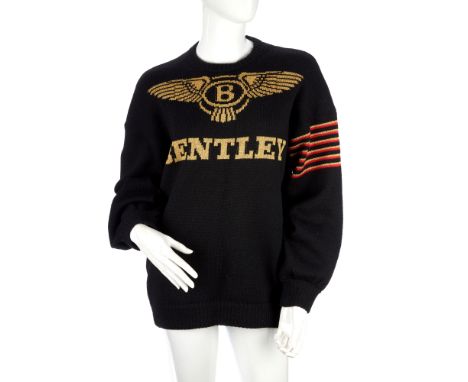 A vintage jumper, black hand knitted wool, featuring a large gold Bentley logo, by George Hostler, chest measures approximate