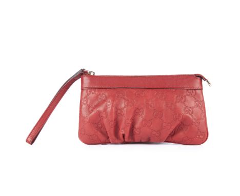 Gucci, a red Guccissima wristlet pouch, featuring maker's GG embossed leather exterior, with top zip fastening and leather wr