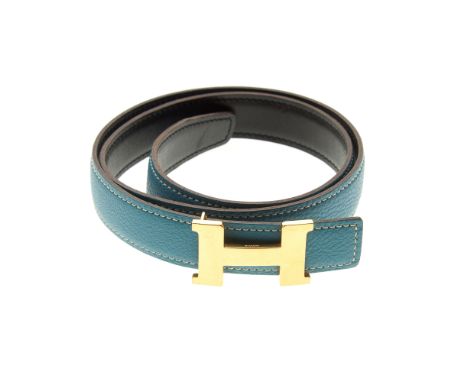Hermes, a reversible Constance 25mm belt, designed with smooth black leather to one side and grained light blue leather to th