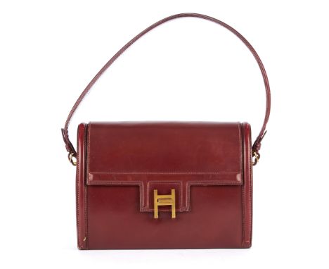 Hermes, a vintage burgundy Sac Rondo handbag, designed with a structured shape from smooth burgundy box calf leather, featuri