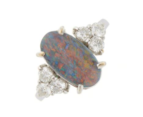 An 18ct gold black opal cabochon dress ring, with brilliant-cut diamond trio sides, opal measures approximately 13.8 by 7.5 b