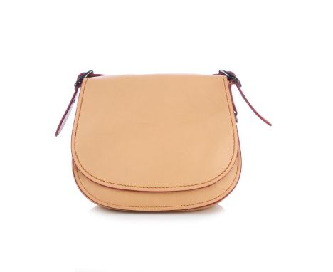 Coach, a Saddle handbag, crafted from nude glovetanned leather, featuring an adjustable shoulder strap, flap closure and ches