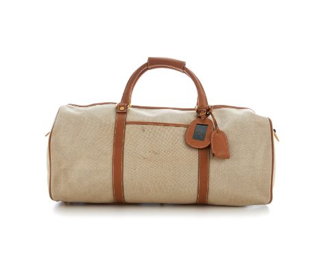 Gucci, a canvas holdall travel bag, crafted from cream canvas with tan leather trim, with a front slip pocket, dual rolled le