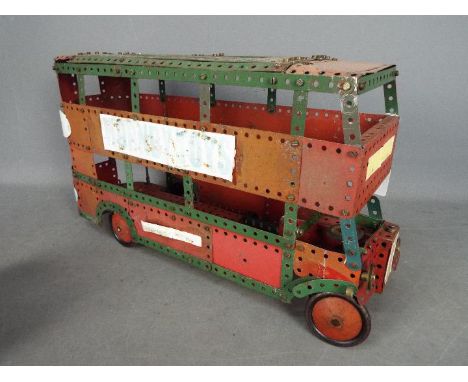 Meccano - A built Meccano London style Double Decker Bus. The model is built from red and green Meccano and shows signs of pl