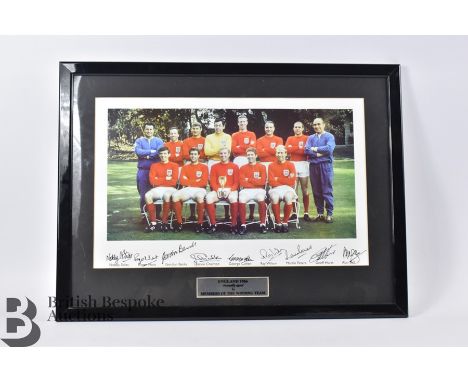 A framed photograph signed by members of the England team who played and won the 1966 World Cup. Signatures include Nobby Sti