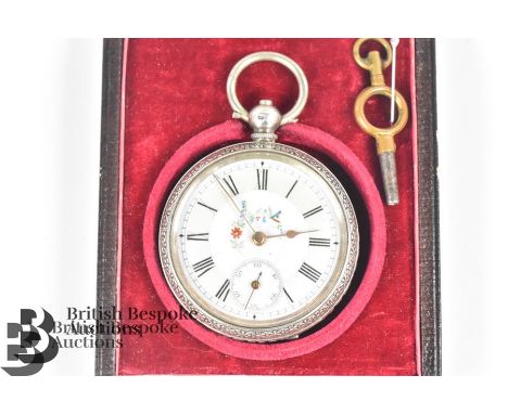 Silver Continental open faced pocket watch. The watch having a floral painted enamel face 32mm with Roman dial, having an eng