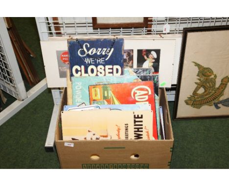 A box containing a quantity of new and as new vintage style advertising signs, enamel and canvas inc. Black & White, Marmite,