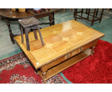 A modern oak coffee table with a shelf stretcher and fitted with drawers