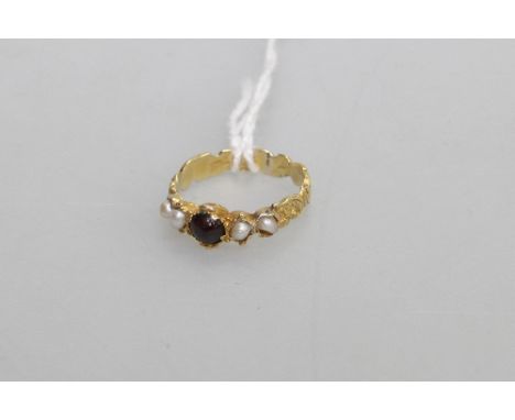 A garnet and pearl ring, on a gold band, unmarked but tested. Size M