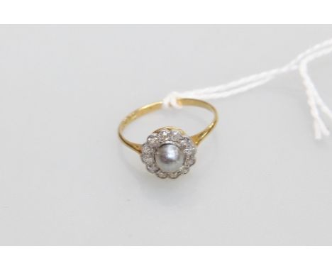 A diamond and single pearl cluster ring on 18ct gold and platinium mount.