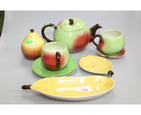 A Carlton Ware novelty apple shaped tea set comprising teapot, two cups, one saucer, two plates, together with a banana shape