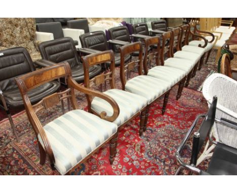 A set of eight Regency mahogany dining chairs, including two carvers, each with a moulded and carved crest rail above a waist