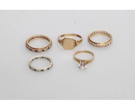 A group of five 9ct gold mounted rings comprising three gem set eternity rings, a solitaire ring and a gold ring, (5)