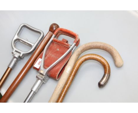 A silver mounted walking stick; tog. with two others and two shooting sticks (5)