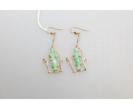 A pair of Chinese jade earrings, in the form of ladies, within yellow metal (probably gold) scroll and faux bamboo mounts, wi
