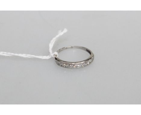 A diamond half hoop eternity ring, the ten round brilliants channel set on a platinum band (stamped "10% irid....."). 