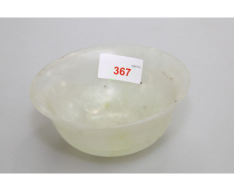 A Chinese pale celadon jade bowl, with everted rim, the base with gilt seal mark referring to the Qianlong Emperor. 