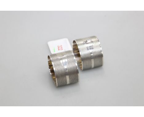 A pair of silver napkin rings, Birmingham 1939, of semi circular form with engine turned decoration, 2 troy ounces