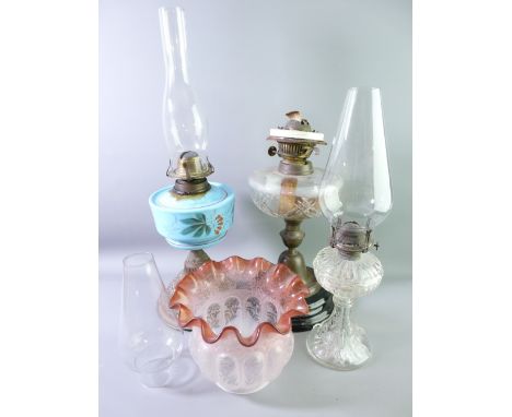 TWO VICTORIAN OIL LAMPS AND ONE OTHER including a cut glass font example with black pot base and frilly edge, tinted, an etch