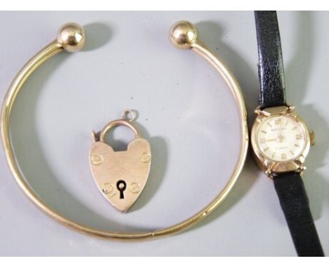 A 9CT GOLD CASED ROTARY LADY'S WRIST WATCH, cuff bangle and an individual padlock clasp, 8.8grms weighable, the watch on slen
