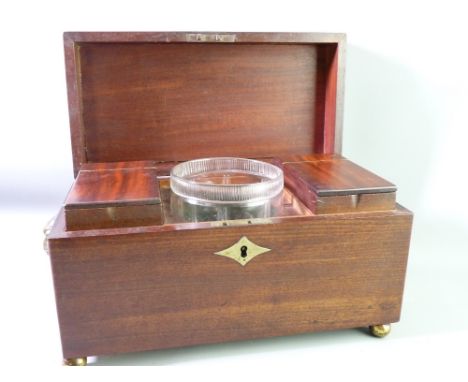 A GEORGIAN MAHOGANY TEA CADDY, lion mask and ring handles (one ring missing) on ball feet, two interior cannisters with centr