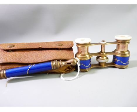 A CONTINENTAL PAIR OF FOLDING OPERA GLASSES, gilt metal with mother of pearl eye pieces, blue enamel with gilt floral swag de