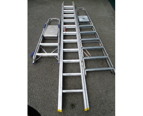 AN EXTENDING ALUMINIUM LADDER and two sets of step ladders, 5.1m open, the extender
