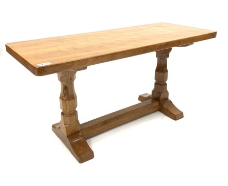 'Mouseman' adzed Yorkshire oak coffee table, rectangular top raised on octagonal supports with sledge feet, united by floor s