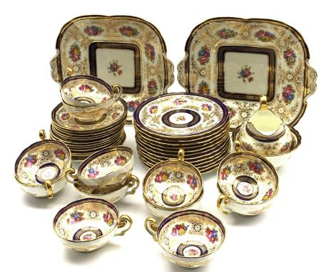 Cauldon tea service decorated with sprays of flowers within a blue and gilt leaf pattern border comprising twelve cups and sa