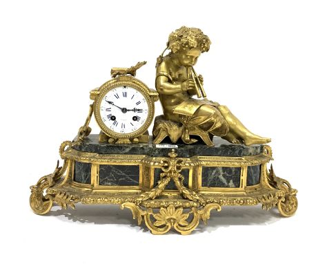 Late 19th century figural French mantel clock, with gilt metal child playing instrument on marble panel, the base having gadr